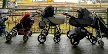 Mães polonesas deixam carrinhos de bebê à espera de mães ucranianas refugiadas, em estação